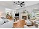 Spacious living room featuring fireplace, ceiling fan, light gray walls, and open to the dining area at 261 Mossy Oak Way, Mount Pleasant, SC 29464