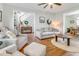 Comfortable living room with fireplace, ceiling fan, light gray walls, and opening to the entry at 261 Mossy Oak Way, Mount Pleasant, SC 29464