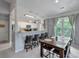 Well-lit dining area next to kitchen with natural lighting and barstool seating at 2632 Egret Crest Ln, Charleston, SC 29414