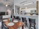 Open dining area adjacent to the kitchen, featuring a large wooden table and barstool seating at 2632 Egret Crest Ln, Charleston, SC 29414