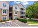 A tan condo building featuring screened in balconies and lush green landscaping at 2632 Egret Crest Ln, Charleston, SC 29414