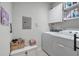 Efficient laundry area with storage cabinets, shelving, washer, and dryer at 2632 Egret Crest Ln, Charleston, SC 29414