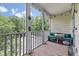 Charming, covered patio with comfortable seating, decorative string lights, and private wooded views at 2632 Egret Crest Ln, Charleston, SC 29414