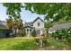 Expansive backyard featuring a mature palm, well-kept lawn, string lights, and cozy patio area at 2900 Split Hickory Ct, Johns Island, SC 29455