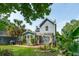 Exterior of home displaying the backyard, with patio, mature palms, and lush green lawn at 2900 Split Hickory Ct, Johns Island, SC 29455