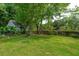 Lush green backyard with mature trees, a wooden fence, and well-maintained lawn at 2900 Split Hickory Ct, Johns Island, SC 29455