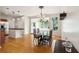 Bright dining room boasts wood floors, contemporary chandelier, and natural light from adjacent sunroom at 2900 Split Hickory Ct, Johns Island, SC 29455