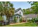 Charming two-story home showcasing well-manicured lawn, mature landscaping, and a cozy patio at 2900 Split Hickory Ct, Johns Island, SC 29455