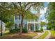 Beautiful two-story home with double porches, lush landscaping, and a private driveway at 2900 Split Hickory Ct, Johns Island, SC 29455