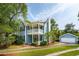 Charming two-story home with a double porch, manicured lawn, and an adjacent garage at 2900 Split Hickory Ct, Johns Island, SC 29455