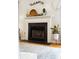 Fireplace with hearth, mantel, and decorative items and plants on a hardwood floor at 2900 Split Hickory Ct, Johns Island, SC 29455