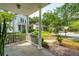 Inviting front porch with elegant columns and a view of the beautifully landscaped neighborhood at 2900 Split Hickory Ct, Johns Island, SC 29455