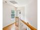 Upstairs hallway with hardwood floors, natural light, and view of the stairway at 2900 Split Hickory Ct, Johns Island, SC 29455