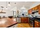 Open kitchen showcases stainless appliances, wood cabinets, and a view to adjacent dining room at 2900 Split Hickory Ct, Johns Island, SC 29455