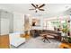 Sunlit living room with hardwood floors and an open layout to the kitchen and dining area at 2900 Split Hickory Ct, Johns Island, SC 29455