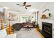 Spacious living room with hardwood floors and fireplace; open to kitchen and dining room at 2900 Split Hickory Ct, Johns Island, SC 29455