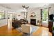 Open-concept living room with hardwood floors, fireplace, and abundant natural light at 2900 Split Hickory Ct, Johns Island, SC 29455