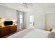 Nicely appointed bedroom with hardwood floors, a gray area rug, and ensuite bathroom at 2900 Split Hickory Ct, Johns Island, SC 29455
