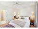 Well-lit bedroom featuring hardwood floors, patterned rug, and open doorway to another room at 2900 Split Hickory Ct, Johns Island, SC 29455