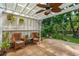 Covered patio with white pergola, ceiling fan, and seating overlooking a lush garden at 2900 Split Hickory Ct, Johns Island, SC 29455