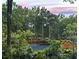 Scenic view of a serene pond surrounded by lush greenery and vibrant landscaping at 2900 Split Hickory Ct, Johns Island, SC 29455