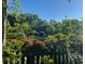 Picturesque pond view surrounded by lush greenery and vibrant red flowers at 2900 Split Hickory Ct, Johns Island, SC 29455