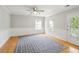 Spacious room with hardwood floors, wainscoting, two windows, and a patio door at 2900 Split Hickory Ct, Johns Island, SC 29455