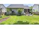 Large backyard showing the patio, a garden and plenty of green space at 3061 Penny Ln, Johns Island, SC 29455