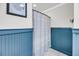 Bathroom with blue wainscotting, tile floor, and shower with curtain at 3061 Penny Ln, Johns Island, SC 29455