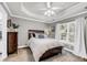 Bedroom features a tray ceiling, large window, and neutral decor at 3061 Penny Ln, Johns Island, SC 29455