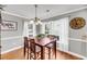 Dining area features wood table, chairs, and natural light from windows at 3061 Penny Ln, Johns Island, SC 29455