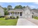 Charming single-Gathering home with a well-manicured lawn and inviting front porch at 3061 Penny Ln, Johns Island, SC 29455