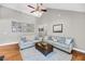 Spacious living room showcasing a vaulted ceiling, hardwood floors, and neutral decor at 3061 Penny Ln, Johns Island, SC 29455