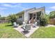 Back patio with four chairs and a small table, perfect for outdoor entertaining at 3061 Penny Ln, Johns Island, SC 29455