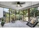 Relaxing screened-in porch with porch swing and wooded view at 3061 Penny Ln, Johns Island, SC 29455