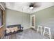 Relaxing screened porch featuring a swing with plush pillows and neutral color scheme at 3061 Penny Ln, Johns Island, SC 29455