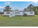 Inviting single-story home featuring blue shutters, a well-manicured lawn, and ample parking at 307 Glen St, Summerville, SC 29483