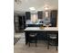 Modern kitchen with stainless steel appliances, island with seating, and sleek black cabinetry at 307 Glen St, Summerville, SC 29483