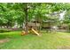 Lush backyard showcasing wooden playset and play area at 3092 Morningdale Dr, Mount Pleasant, SC 29466