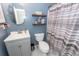 Comfortable bathroom featuring a vanity sink, toilet, and decorative floating shelves at 3092 Morningdale Dr, Mount Pleasant, SC 29466