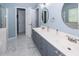 Bathroom featuring double vanity with grey cabinets, white marble floors and walk in shower at 3092 Morningdale Dr, Mount Pleasant, SC 29466