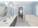 Bathroom featuring double vanity, large tub, and doorway to the bedroom at 3092 Morningdale Dr, Mount Pleasant, SC 29466