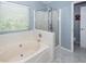 Bathroom featuring a relaxing soaking tub, a separate shower, and white tile at 3092 Morningdale Dr, Mount Pleasant, SC 29466