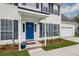 Beautiful front of home featuring blue door, white siding, well-manicured flower beds, and shuttered windows at 3092 Morningdale Dr, Mount Pleasant, SC 29466