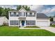 Beautiful home with a blue door, manicured lawn, black shutters, and an attached two-car garage at 3092 Morningdale Dr, Mount Pleasant, SC 29466