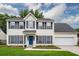Charming two-story home featuring blue shutters, a well-manicured lawn, and an attached two-car garage at 3092 Morningdale Dr, Mount Pleasant, SC 29466