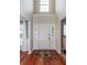 Bright foyer with hardwood floors, sidelights flanking the front door, and a floral rug, creating a welcoming entrance at 3092 Morningdale Dr, Mount Pleasant, SC 29466