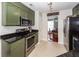 Functional kitchen with green cabinets, black countertops, and stainless steel appliances, offering practicality at 3092 Morningdale Dr, Mount Pleasant, SC 29466