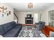 Well-lit living room features fireplace, plush seating, and hardwood floors at 3092 Morningdale Dr, Mount Pleasant, SC 29466
