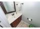 A powder room with a wood vanity and light green walls at 3092 Morningdale Dr, Mount Pleasant, SC 29466